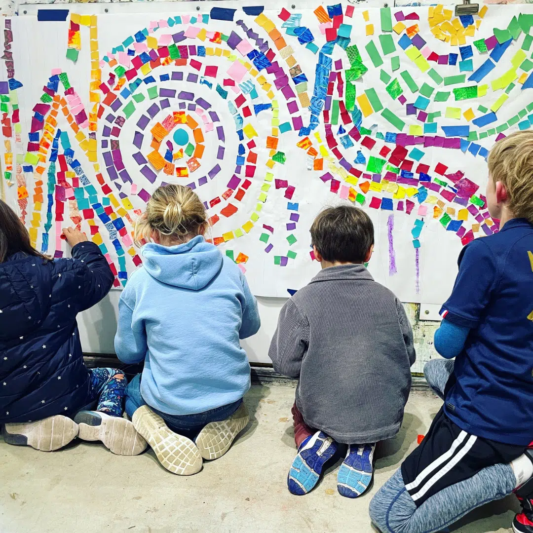 children making mural on wall