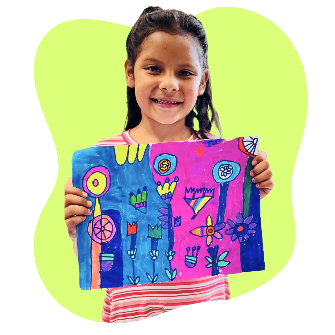child holding up her artwork