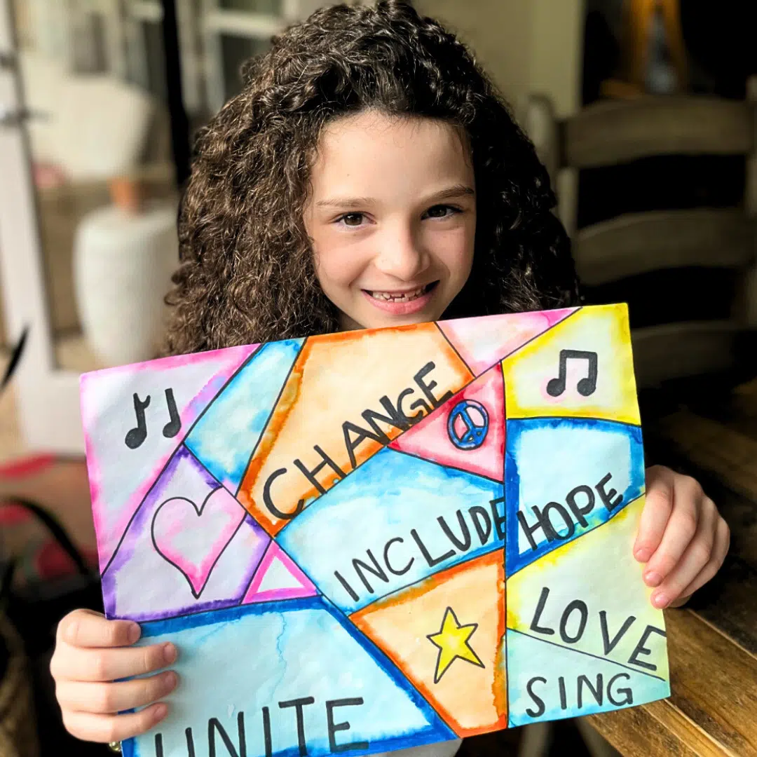 child showing her artwork
