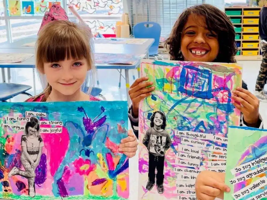 children holding artwork