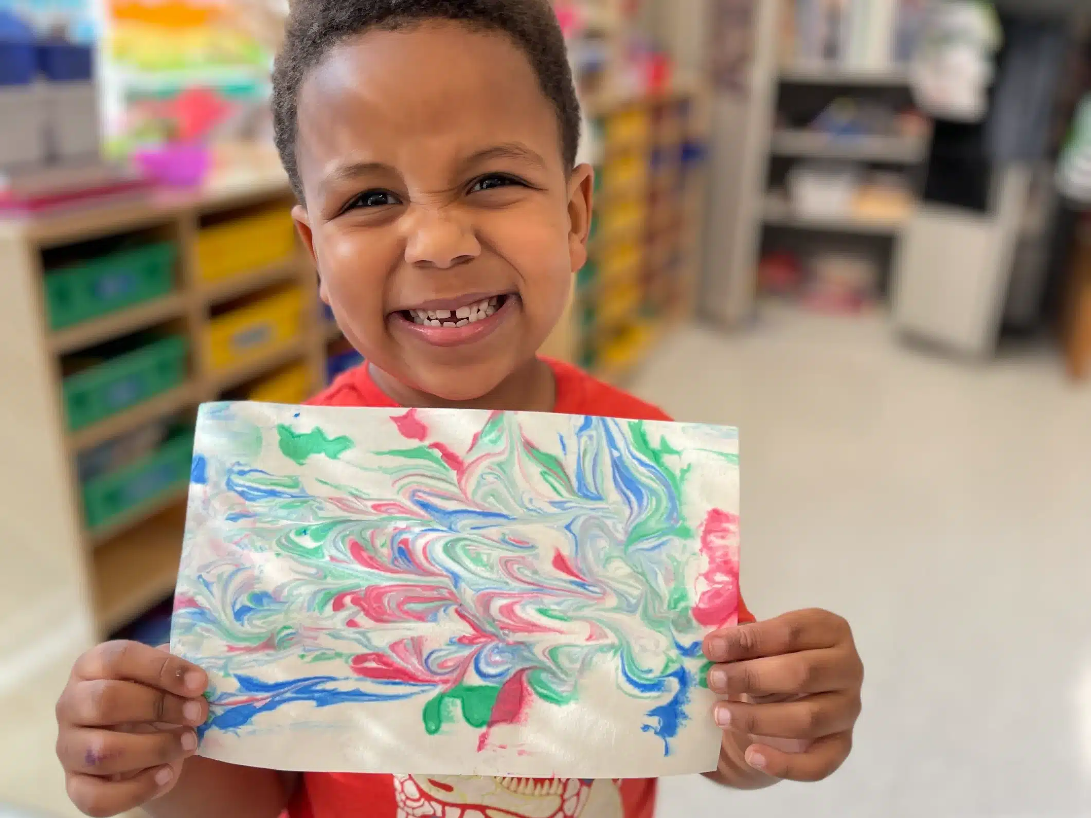 child holding artwork